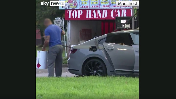 Manchester motorist fills up drum on the forecourt amidst fuel supply crisis