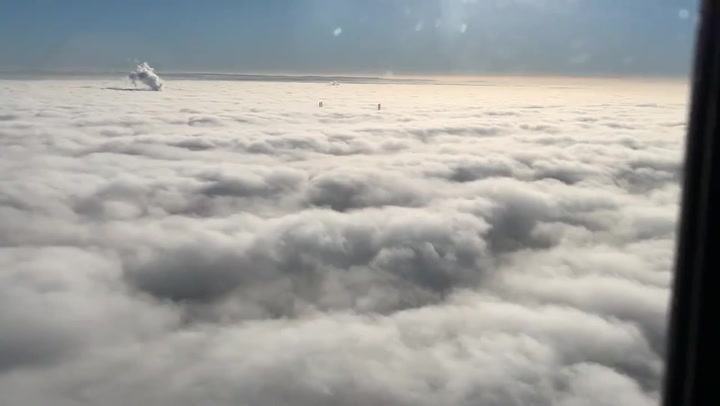 Police helicopter footage shows thick blanket of fog with bridge poking out