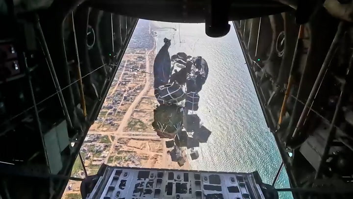 Moment US military airdrop aid onto Gaza beach