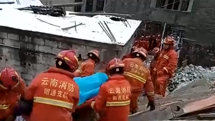 China landslide: Rescuers pull survivors from rubble as villagers missing