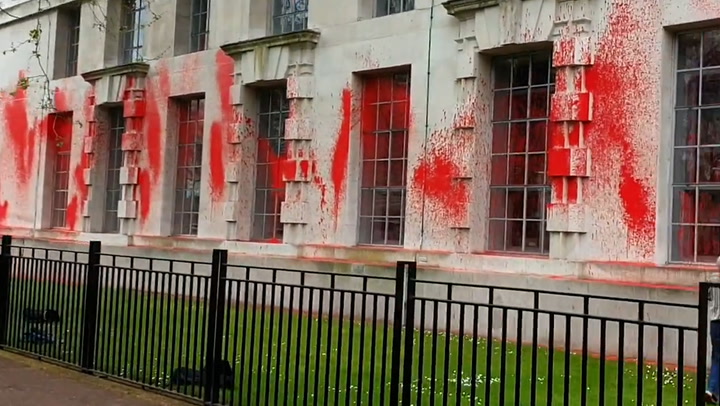 Pro-Palestine protesters scale Ministry of Defence railings to cover building in red paint
