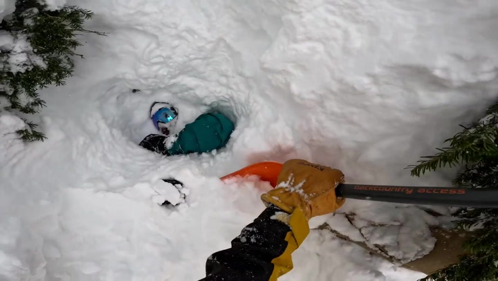 Moment snowboarder buried in avalanche is rescued in dramatic bodycam footage