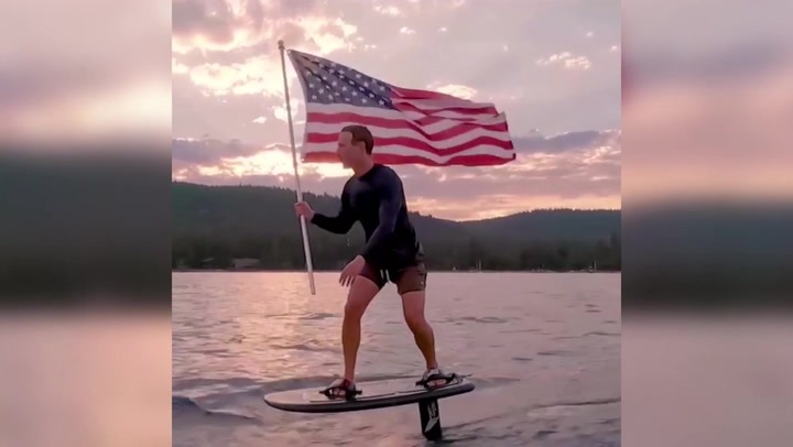 Mark Zuckerberg wakeboards across lake waving US flag