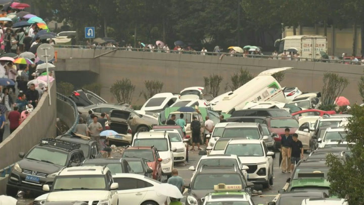 China flooding: Cars pile-up on road following extreme weather conditions