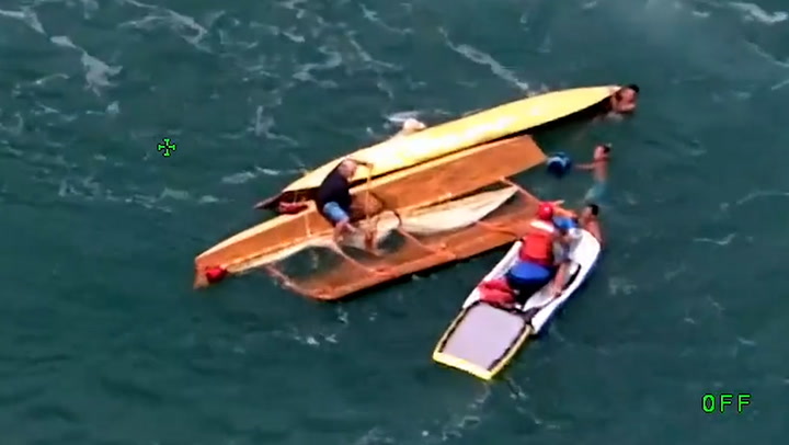 Aerial footage shows moment 11 people are rescued after their boat snapped in half