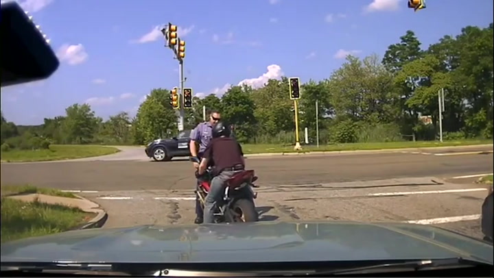 Motorcyclist flees after pushing police officer into traffic