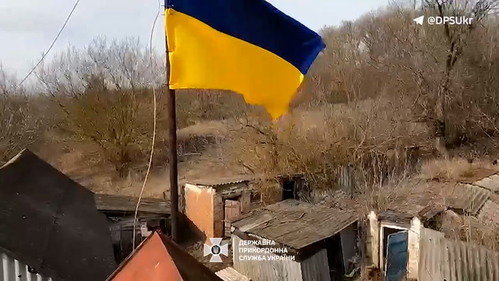 Ukrainian flag raised by soldiers after 'grey zone' towns on border reclaimed