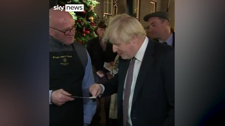 Boris Johnson enjoys food and drink at Downing Street Christmas market