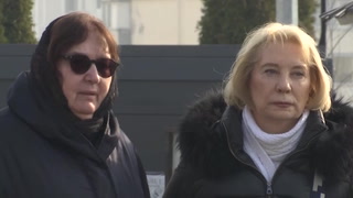Alexei Navalny’s mother comforted by mourners at Putin critic’s grave