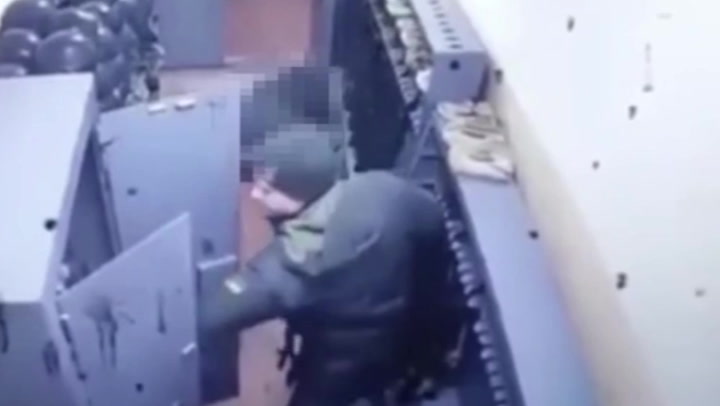 CCTV appears to show Ukrainian soldier raiding cupboards at missile factory after shooting five