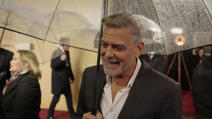 George Clooney jokes about his age as he braves rain for The Boys in the Boat premiere