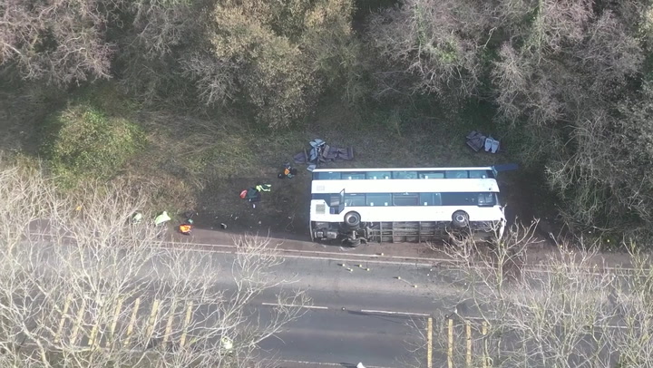 Aerial footage shows police on scene after bus overturns in Somerset