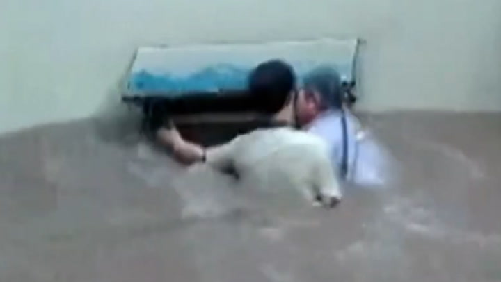 Elderly woman rescued from floods in China by man who can't swim