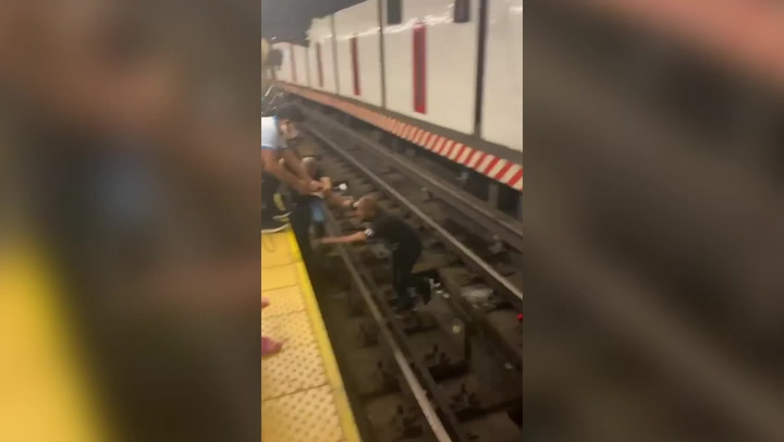 Good samaritan leaps onto NYC subway tracks to rescue man in wheelchair