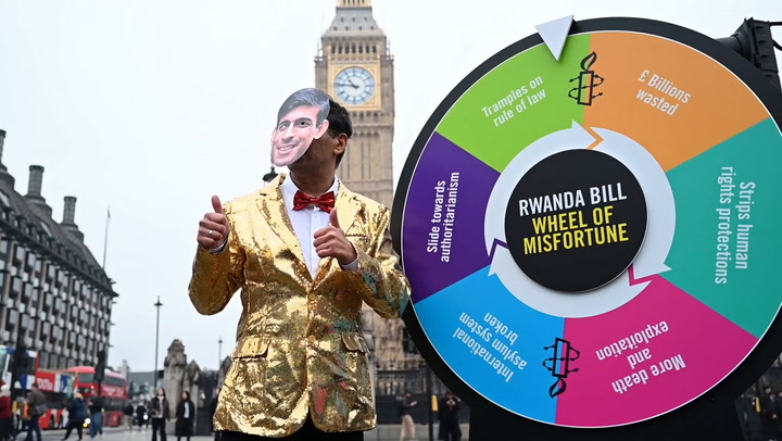Rishi Sunak lookalike plays dystopian 'wheel of fortune' outside Houses of Parliament