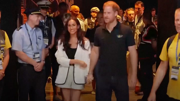 Meghan and Harry walk holding hands to join crowds at Invictus Games