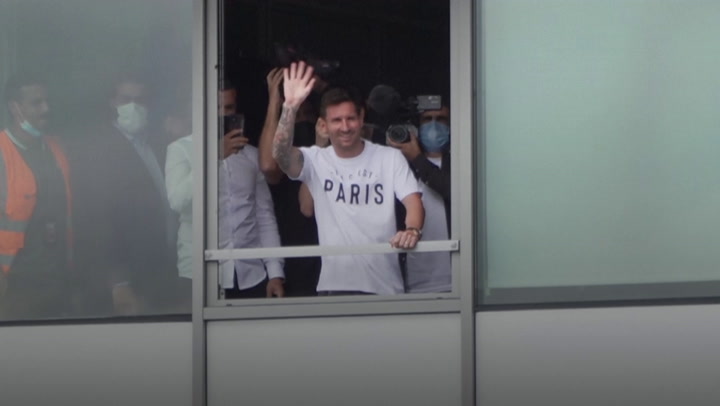 Lionel Messi waves to fans from Paris airport window amid PSG signing