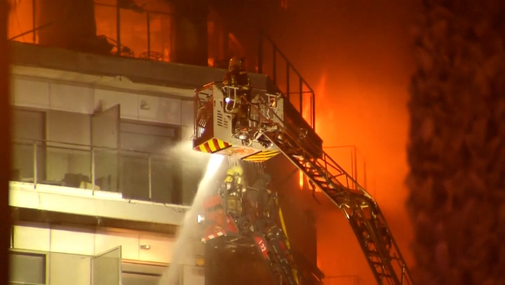 Moment residents trapped in burning Valencia apartments rescued by firefighters