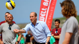 William joins in volleyball game with children on Cornwall beach