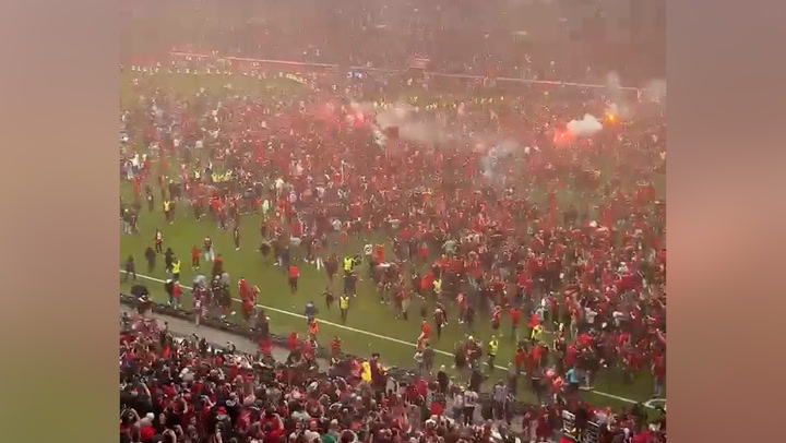 Thousands of Bayer Leverkusen fans storm pitch as club win historic Bundesliga title