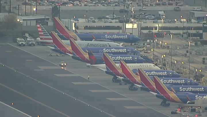 Rows of Southwest planes parked in California as thousands of flights cancelled