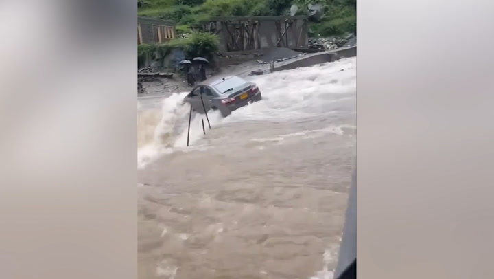 Car swept away by gushing floodwaters in Pakistan