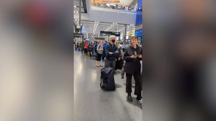 Queue snakes through Dublin Airport terminal at 3am as passengers wait at bag drop
