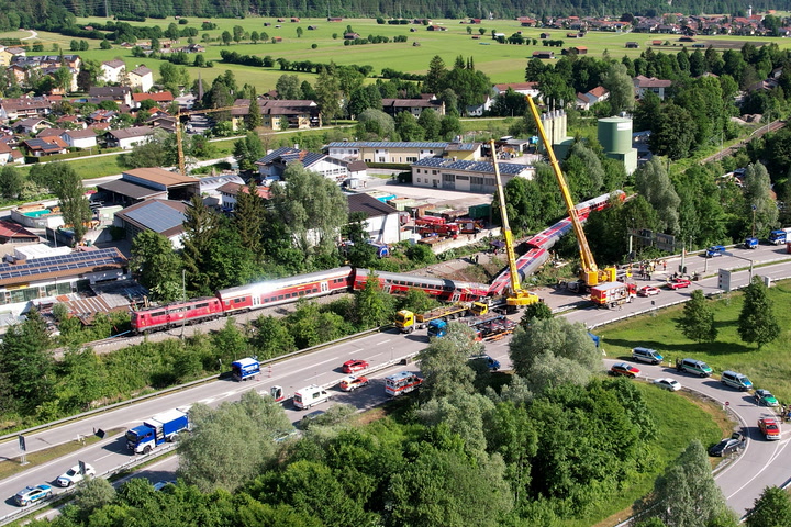 German emergency services attend crash site after train derails, killing at least four