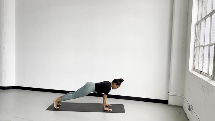 Woman doing low plank pose chaturanga dandasana ex