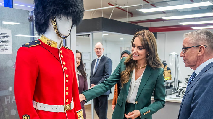 Kate gets the measure of guardsman’s uniform on visit to Yorkshire textile mill