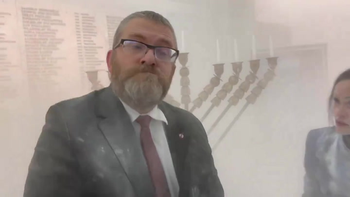 Polish MP Grzegorz Braun sprays Hanukkah menorah with fire extinguisher