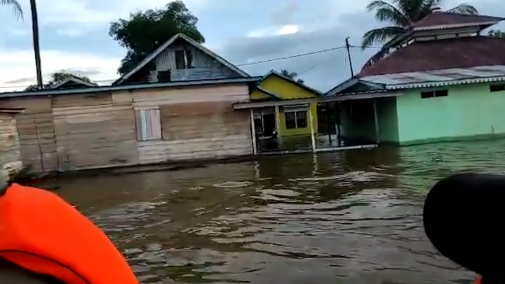 Houses metres deep in flood water after Indonesia floods displace thousands