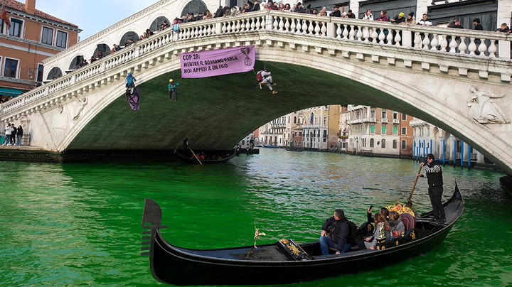 Climate activists turn Venice’s Grand Canal green in Cop28 protest