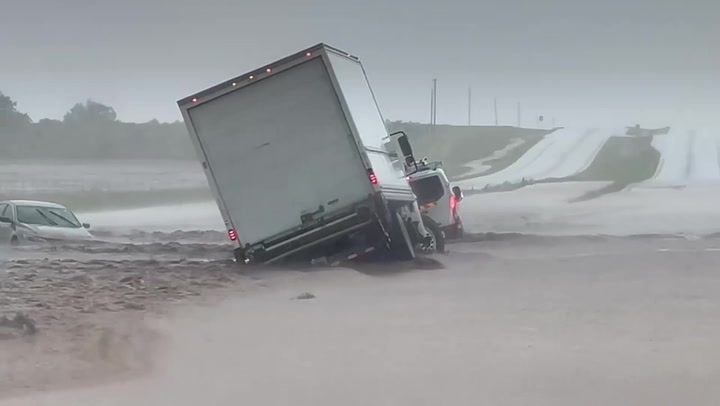 Powerful flash flood submerges and washes vehicles off Texas highway