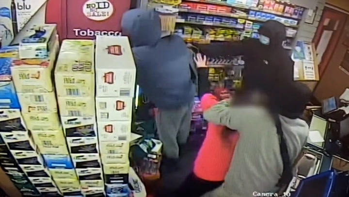 Trio of masked robbers threaten female shop worker with axe during robbery