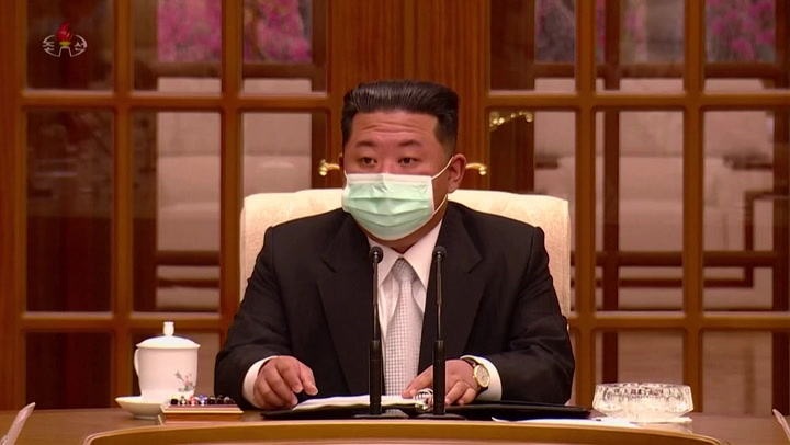 Kim Jong-un wears face mask for first time as he discusses Covid outbreak with officials