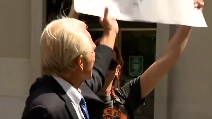 Former Trump advisor Peter Navarro attempts to snatch 'Trump lost' sign from protester