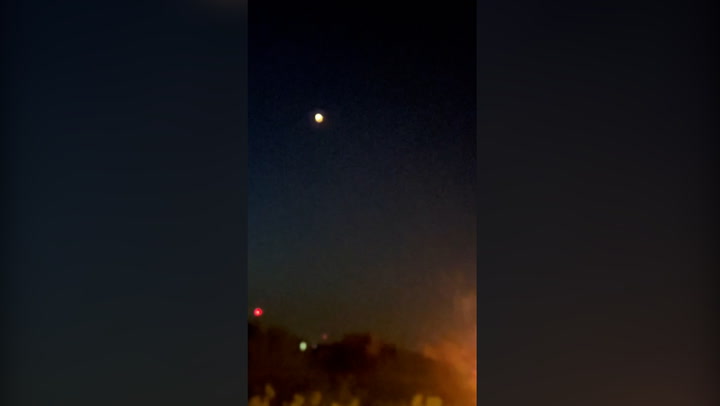 Explosions heard as blast of light seen over Iran city in suspected Israel missile attack