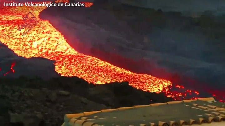 A 'tsunami' of molten lava overflows a volcanic channel on the Canary Islands