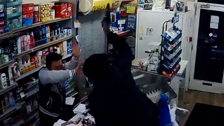 Screaming shopkeeper fights off armed robber in east London