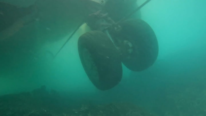 Divers explore US spy plane wreck after aircraft ploughed off runway into Hawaii bay