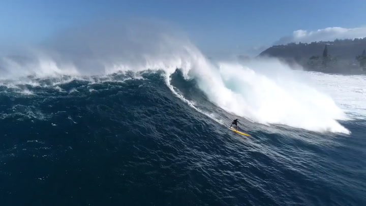 Drone captures surfers riding waves in Hawaii