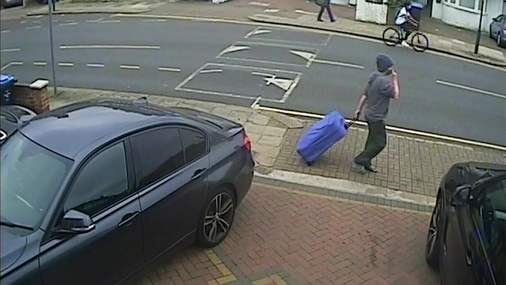 CCTV captures osteopath accused of murdering neighbour walking with bulky suitcase