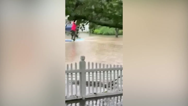 Man seen paddleboarding on two-feet-deep flooding in Rye, New York