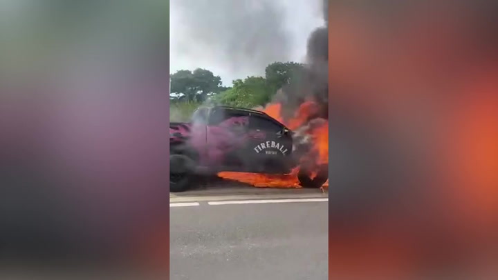 Fireball Whiskey truck catches fire on side of motorway