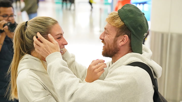Sam Thompson greeted by girlfriend Zara McDermott as he arrives back after I'm a Celeb victory