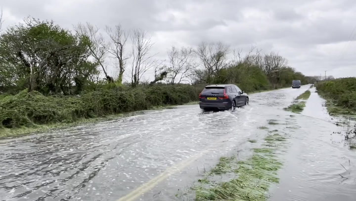 Cars wade through flooded Sussex roads following Storm Kathleen