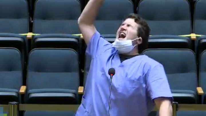 YouTuber dressed in scrubs performs Covid vaccine rap at council meeting
