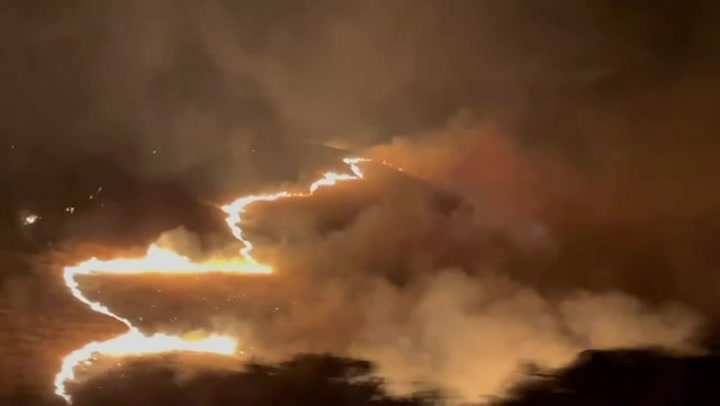 Huge bush fire breaks out dangerously close to a busy freeway in California