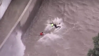 Moment woman rescued by helicopter from raging LA river